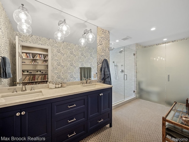 full bath featuring a shower stall, double vanity, and tile patterned floors