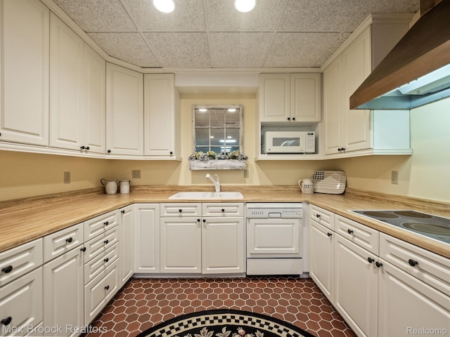 kitchen with dishwasher, wall chimney range hood, white microwave, white cabinets, and electric cooktop