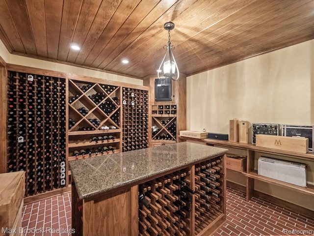 wine room featuring wood ceiling, brick flooring, and recessed lighting