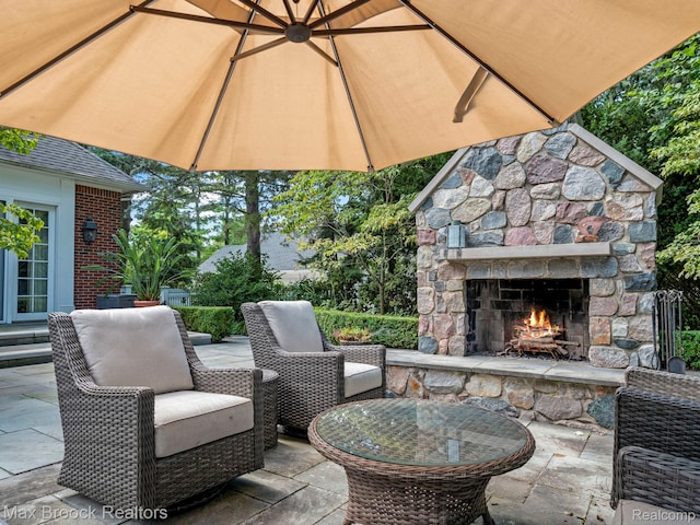 view of patio / terrace with an outdoor stone fireplace