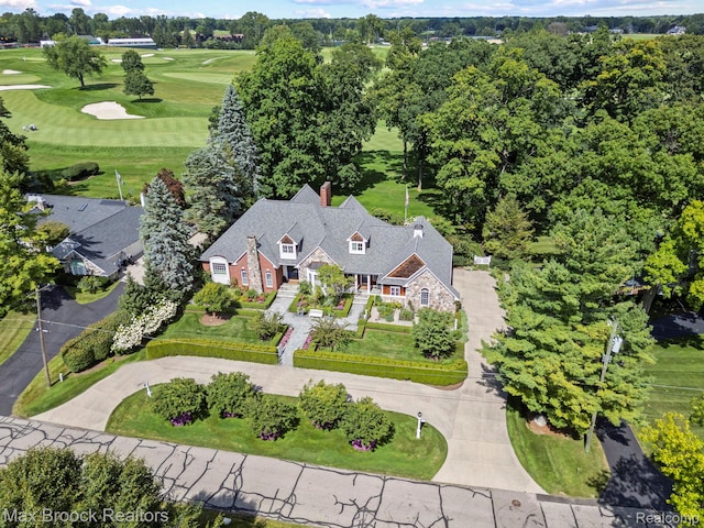 aerial view of property and surrounding area featuring a golf club