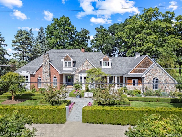 view of front of home featuring stone siding and a chimney