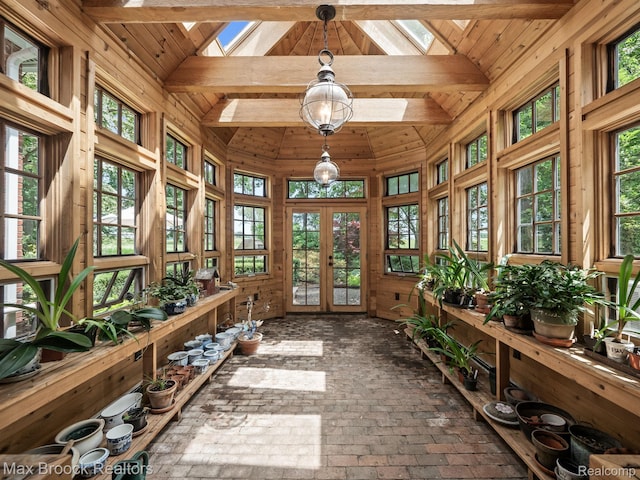 sunroom / solarium with french doors, a skylight, and plenty of natural light