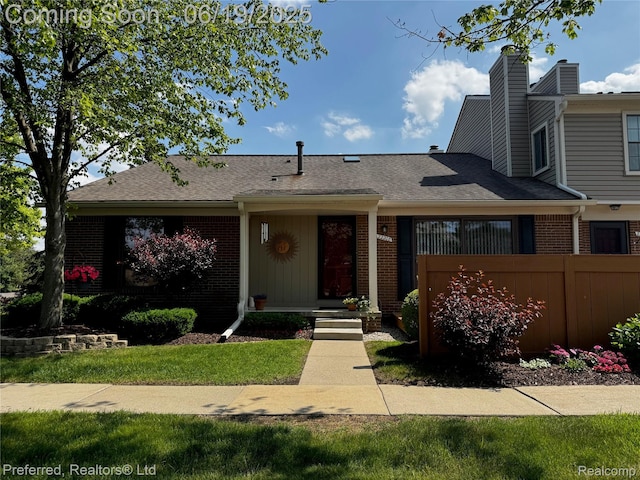 22208 Pondview, Novi, MI 48375 - view of front of house with brick siding, a chimney, and roof with shingles