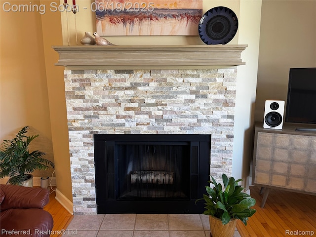 22208 Pondview, Novi, MI 48375 - detailed view of a stone fireplace and wood finished floors