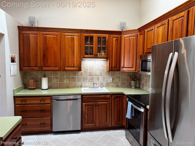 22208 Pondview, Novi, MI 48375 - kitchen featuring appliances with stainless steel finishes, backsplash, light countertops, glass insert cabinets, and brown cabinets