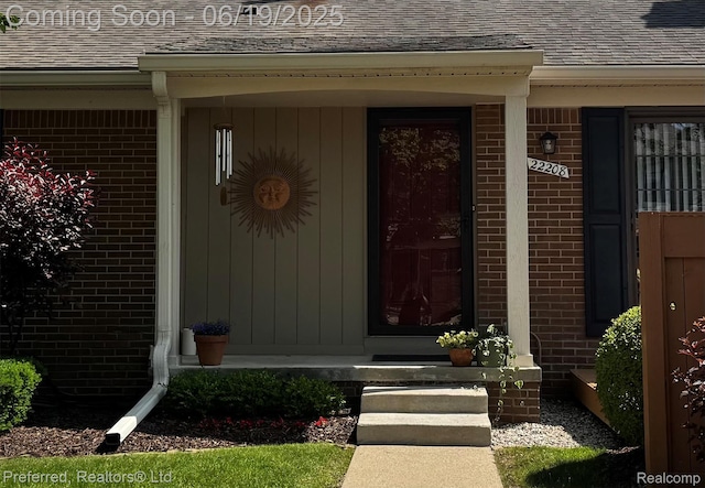 22208 Pondview, Novi, MI 48375 - doorway to property with a shingled roof and brick siding