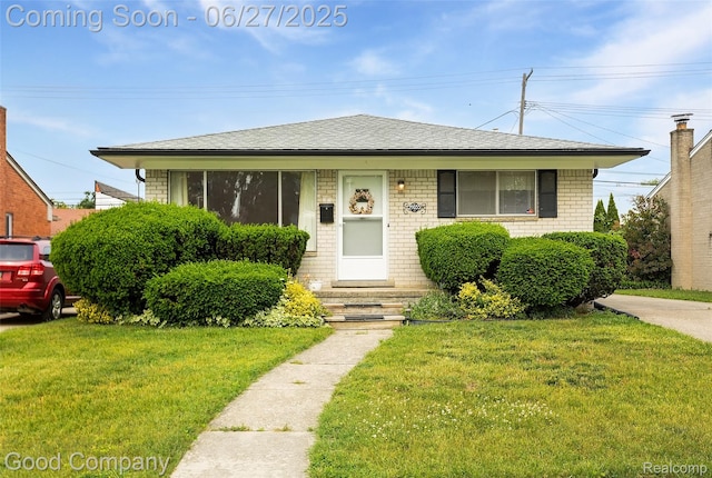 29035 Spoon Ave, Waterford, MI 48071 - bungalow with a front yard, brick siding, and a shingled roof