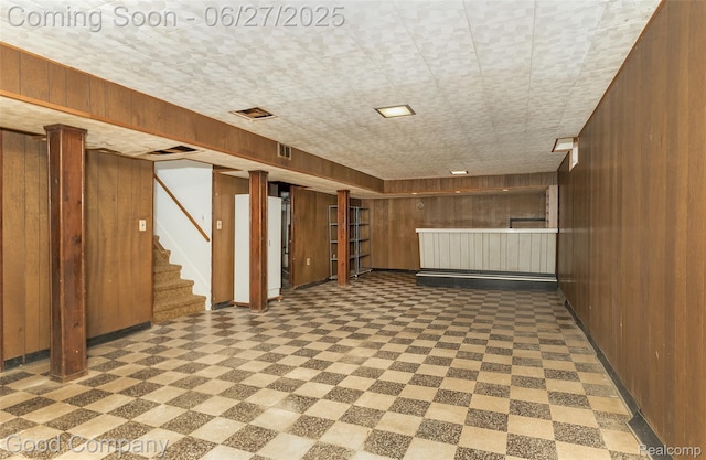 29035 Spoon Ave, Waterford, MI 48071 - finished below grade area featuring wooden walls, tile patterned floors, stairway, and bar area