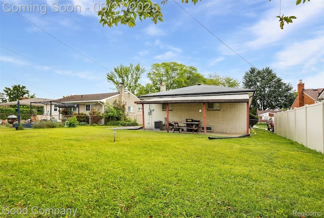 29035 Spoon Ave, Waterford, MI 48071 - rear view of property featuring brick siding, a fenced backyard, and a patio