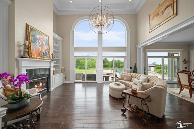 11694 Robinshire St, Temperance, MI 48182 - living area featuring a chandelier, healthy amount of natural light, dark wood finished floors, a tile fireplace, and a high ceiling