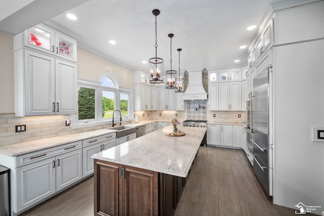11694 Robinshire St, Temperance, MI 48182 - kitchen with custom exhaust hood, stainless steel appliances, a center island, white cabinetry, and a chandelier