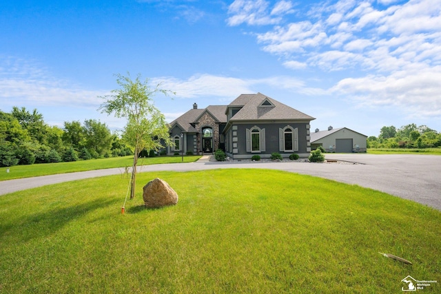 11694 Robinshire St, Temperance, MI 48182 - french country style house featuring a front lawn and stone siding