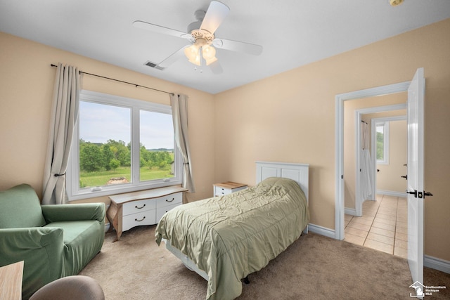 11694 Robinshire St, Temperance, MI 48182 - bedroom featuring light colored carpet, multiple windows, light tile patterned flooring, and a ceiling fan