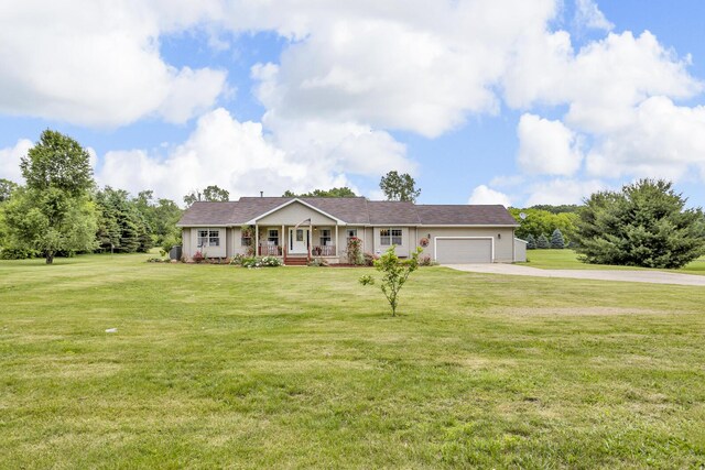 6824 Napoleon Rd, Jackson, MI 49201 - ranch-style house with covered porch, concrete driveway, a garage, and a front yard