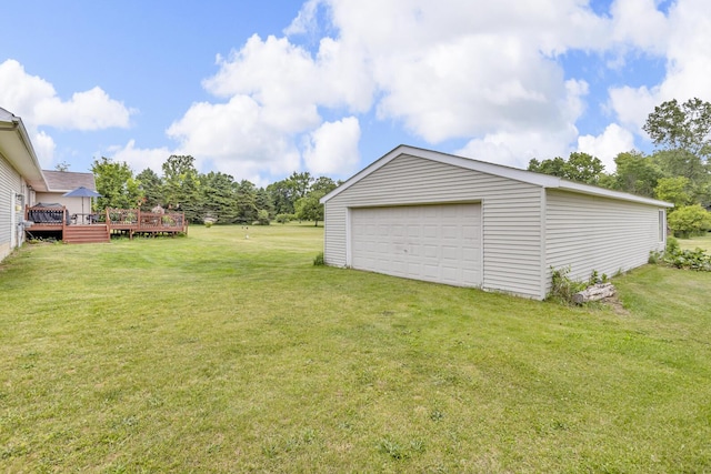 6824 Napoleon Rd, Jackson, MI 49201 - view of grassy yard featuring a wooden deck, an outdoor structure, and a detached garage