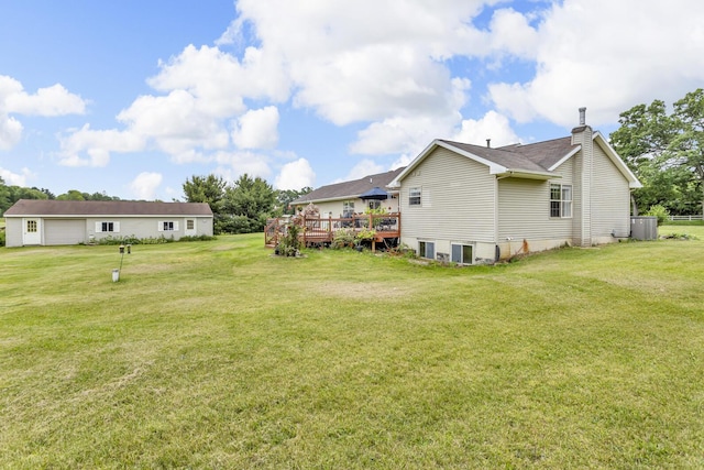 6824 Napoleon Rd, Jackson, MI 49201 - view of grassy yard with a wooden deck and a garage
