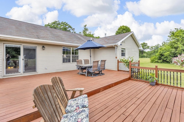 6824 Napoleon Rd, Jackson, MI 49201 - deck with outdoor dining area and a yard