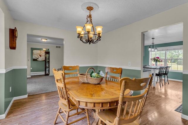 6824 Napoleon Rd, Jackson, MI 49201 - dining area featuring a chandelier and wood finished floors