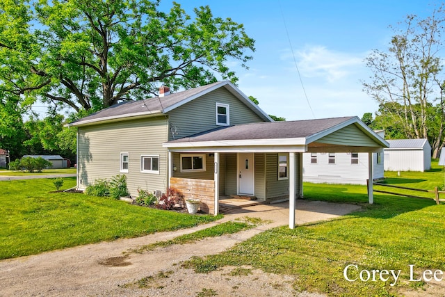 413 W Riverside Dr, Ionia, MI 48846 - view of front facade featuring a front yard, covered porch, and roof with shingles