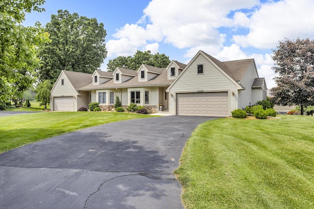 4268 Fairway Ln, Jackson, MI 49201 - cape cod home featuring a front lawn, asphalt driveway, an attached garage, roof with shingles, and stone siding