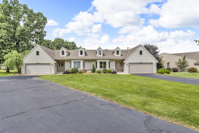 4268 Fairway Ln, Jackson, MI 49201 - cape cod home with a front lawn, asphalt driveway, an attached garage, and roof with shingles