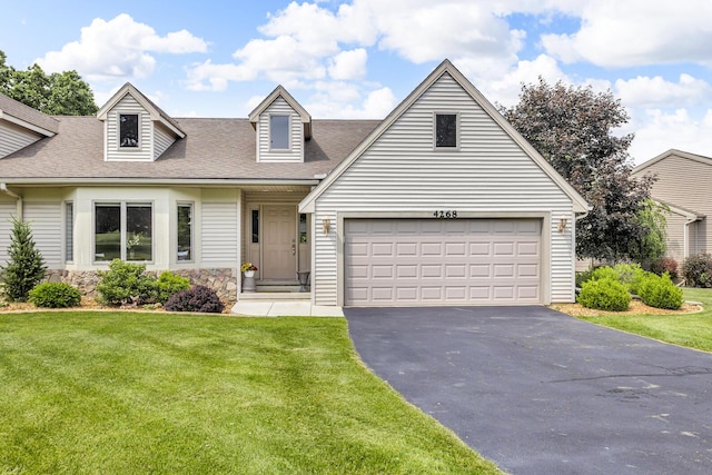 4268 Fairway Ln, Jackson, MI 49201 - cape cod house with asphalt driveway, roof with shingles, a front lawn, and a garage