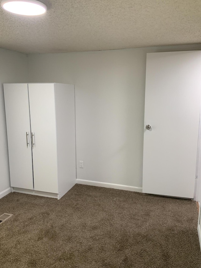 8356 Constitution Blvd, Cadillac, MI 49601 - unfurnished bedroom featuring carpet flooring and a textured ceiling