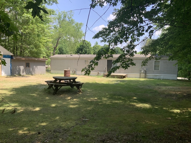 8356 Constitution Blvd, Cadillac, MI 49601 - view of green lawn featuring entry steps and an outbuilding