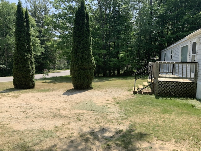8356 Constitution Blvd, Cadillac, MI 49601 - view of green lawn featuring a wooden deck and stairway
