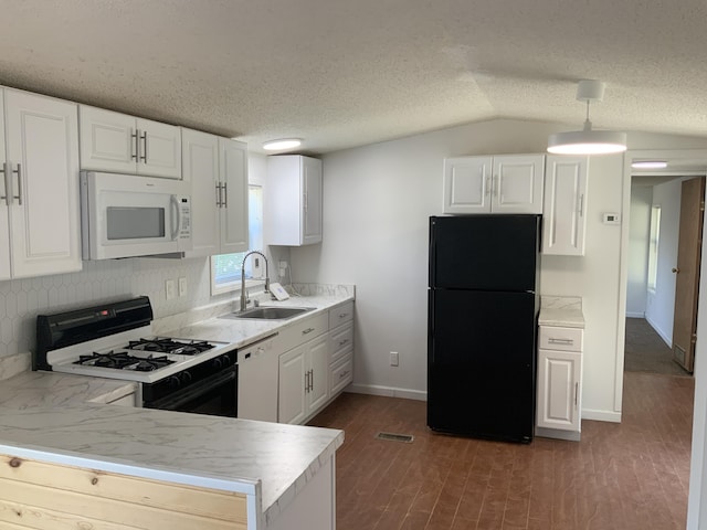 8356 Constitution Blvd, Cadillac, MI 49601 - kitchen featuring white appliances, white cabinets, light countertops, lofted ceiling, and a textured ceiling