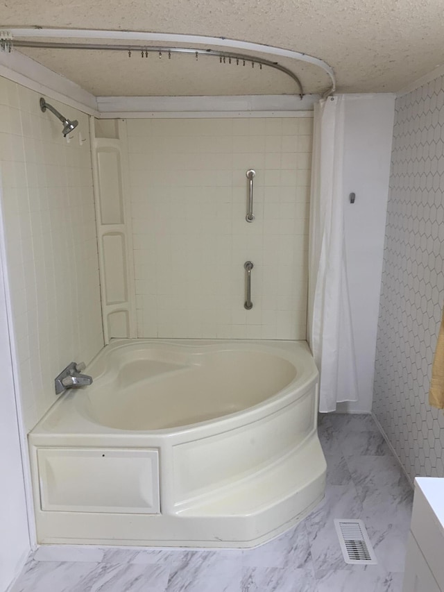 8356 Constitution Blvd, Cadillac, MI 49601 - full bath featuring marble finish flooring, shower / bath combination with curtain, a textured ceiling, and vanity