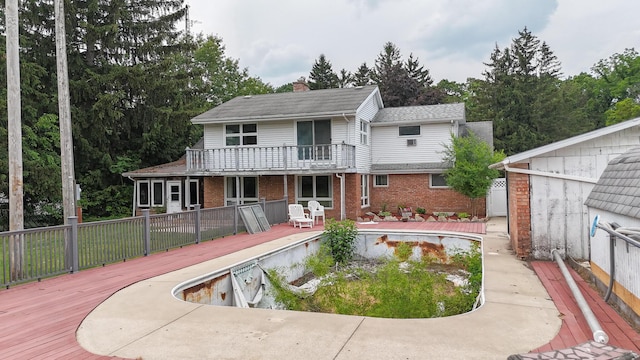 57081 M 51 S, Dowagiac, MI 49047 - rear view of house featuring brick siding, a deck, a balcony, and a chimney