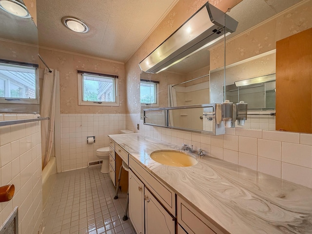 57081 M 51 S, Dowagiac, MI 49047 - full bath with tile patterned floors, tile walls, vanity, shower / tub combo with curtain, and a textured ceiling