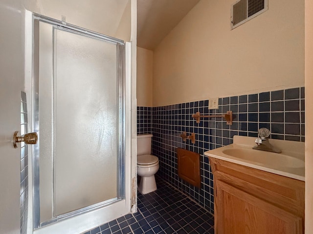 57081 M 51 S, Dowagiac, MI 49047 - bathroom featuring a shower stall, vanity, tile patterned floors, a wainscoted wall, and lofted ceiling
