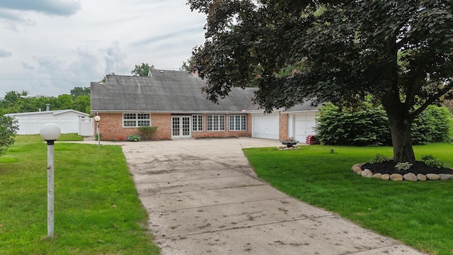 57081 M 51 S, Dowagiac, MI 49047 - view of front of home with driveway, brick siding, french doors, a shingled roof, and a garage