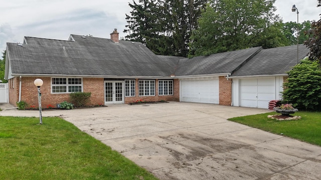 57081 M 51 S, Dowagiac, MI 49047 - view of front of home featuring french doors, a garage, brick siding, driveway, and a front yard