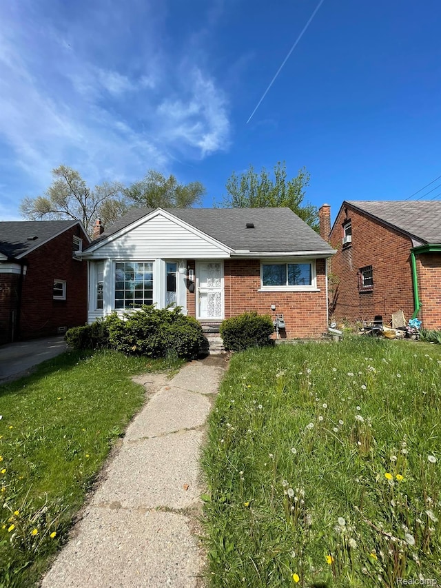 20569 Evergreen Rd, Detroit, MI 48219 - bungalow with brick siding and a front yard