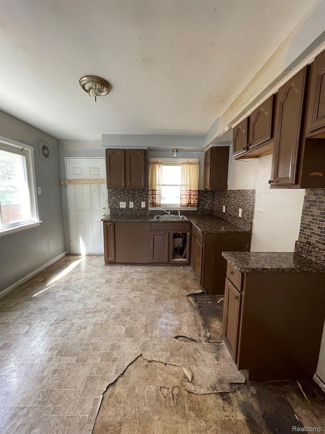 20569 Evergreen Rd, Detroit, MI 48219 - kitchen featuring backsplash and dark stone counters