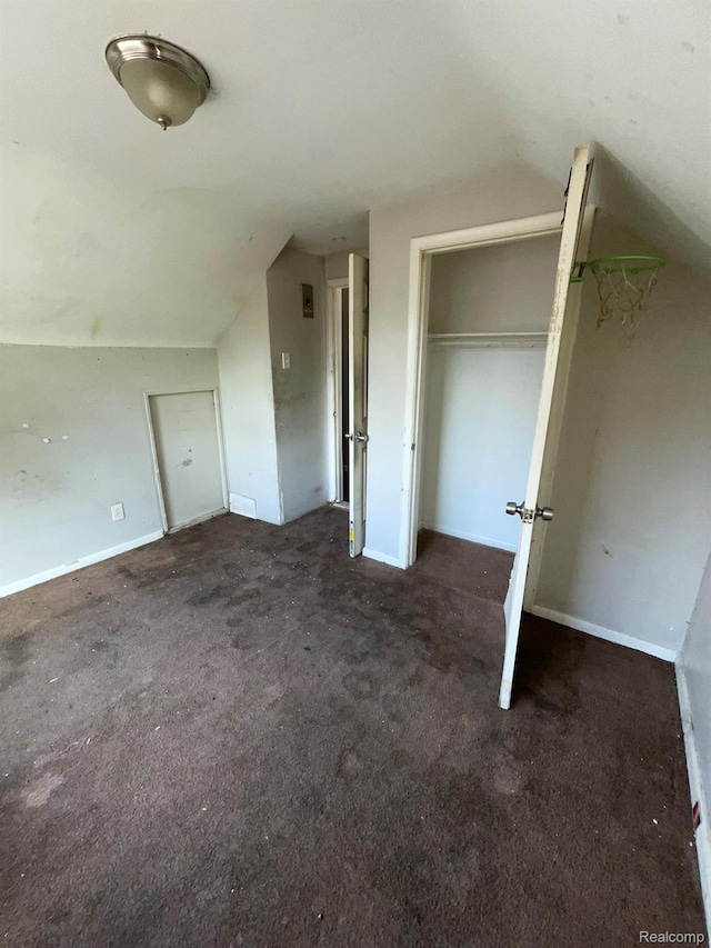 20569 Evergreen Rd, Detroit, MI 48219 - unfurnished bedroom featuring vaulted ceiling and carpet floors