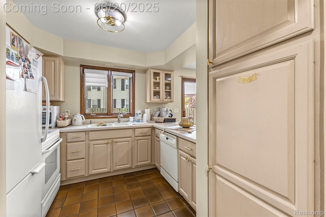 718 S Military St, Dearborn, MI 48124 - kitchen with white appliances, light countertops, dark tile patterned flooring, and glass insert cabinets