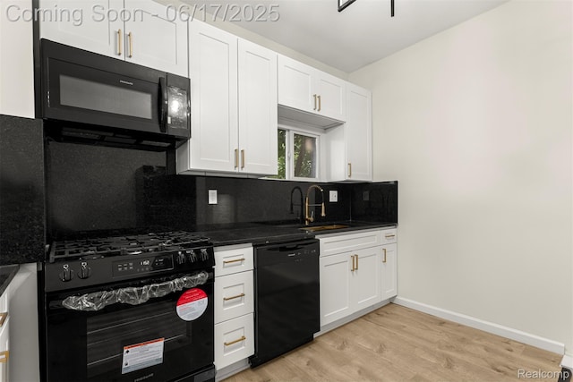 4266 Seminole St, Dearborn, MI 48214 - kitchen with black appliances, light wood-type flooring, tasteful backsplash, and white cabinets