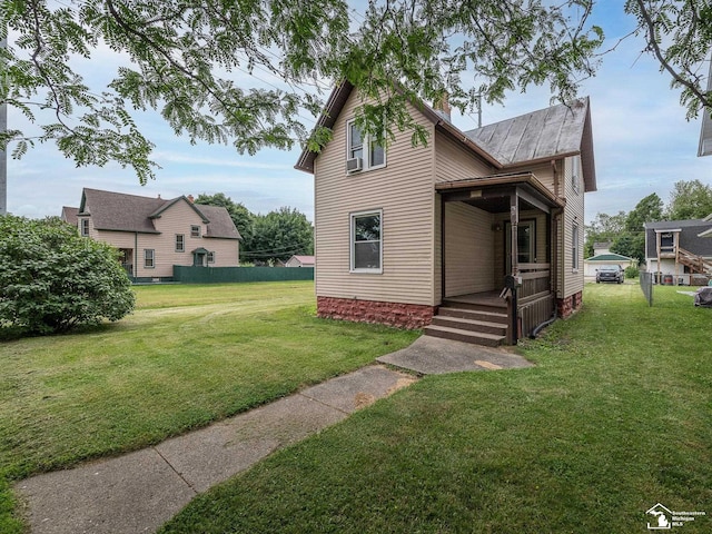 606 E 3rd St, Monroe, MI 48161 - view of front of home featuring a front lawn, a metal roof, and a standing seam roof