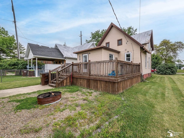 606 E 3rd St, Monroe, MI 48161 - back of house with an outdoor fire pit and a deck