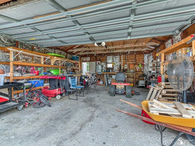 606 E 3rd St, Monroe, MI 48161 - garage featuring a workshop area and a garage door opener