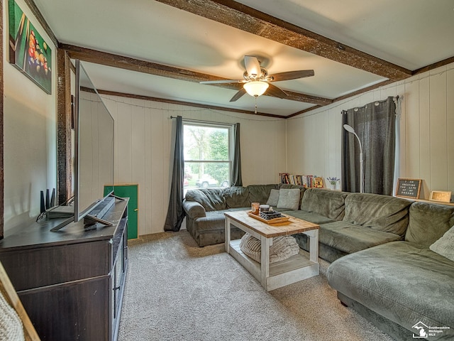 606 E 3rd St, Monroe, MI 48161 - living area with beamed ceiling, ceiling fan, light carpet, and wooden walls