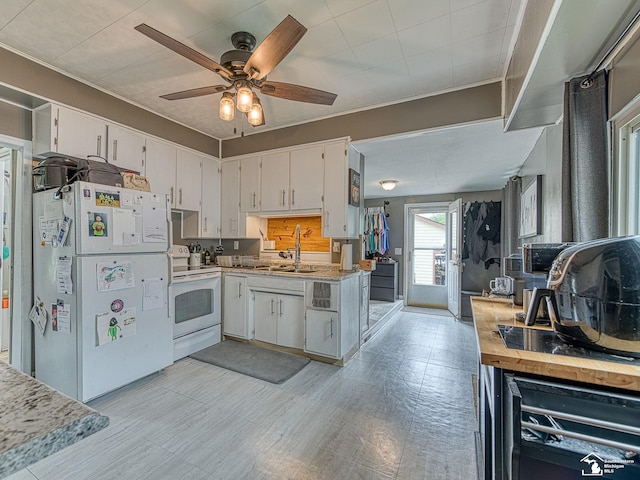 606 E 3rd St, Monroe, MI 48161 - kitchen with white appliances, a ceiling fan, white cabinets, light countertops, and ornamental molding