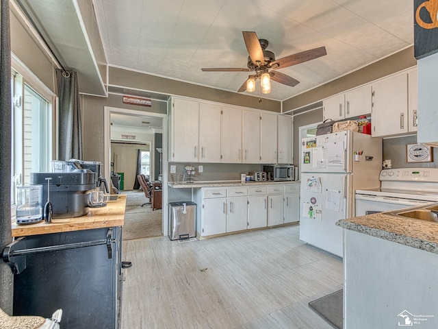 606 E 3rd St, Monroe, MI 48161 - kitchen with white appliances, healthy amount of natural light, a ceiling fan, and white cabinetry
