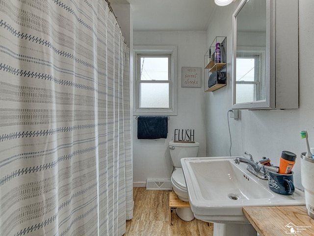606 E 3rd St, Monroe, MI 48161 - bathroom featuring wood finished floors and a shower with shower curtain