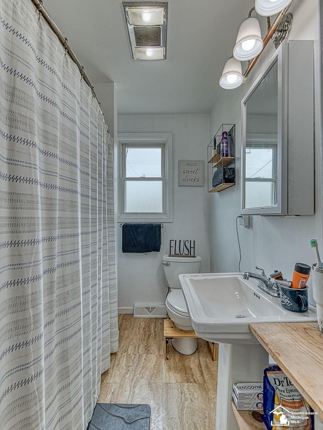 606 E 3rd St, Monroe, MI 48161 - full bathroom with wood finished floors and curtained shower